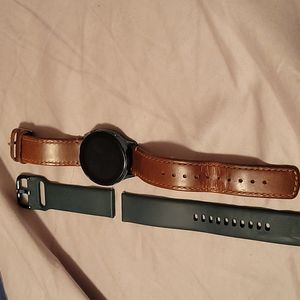 Samsung galaxy watch comes with extra band and charger.